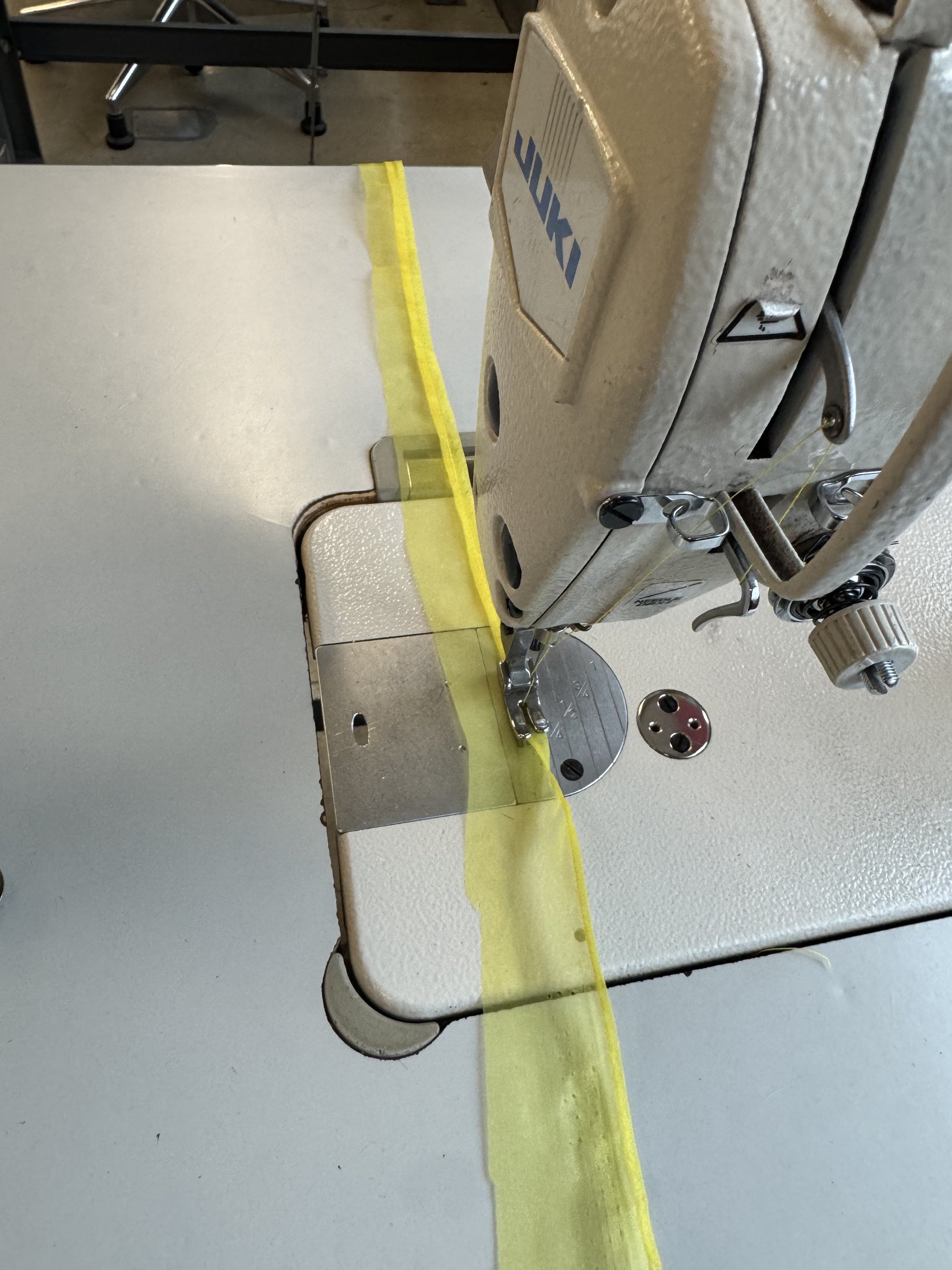 Yellow fabric at the sewing machine