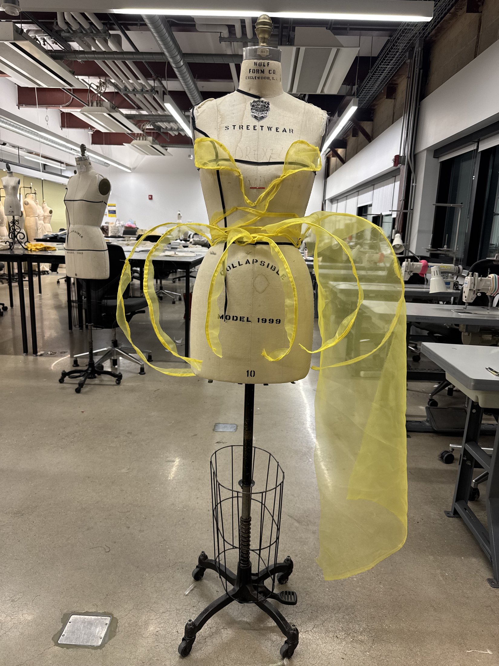 Front view of the sculptural yellow garment study