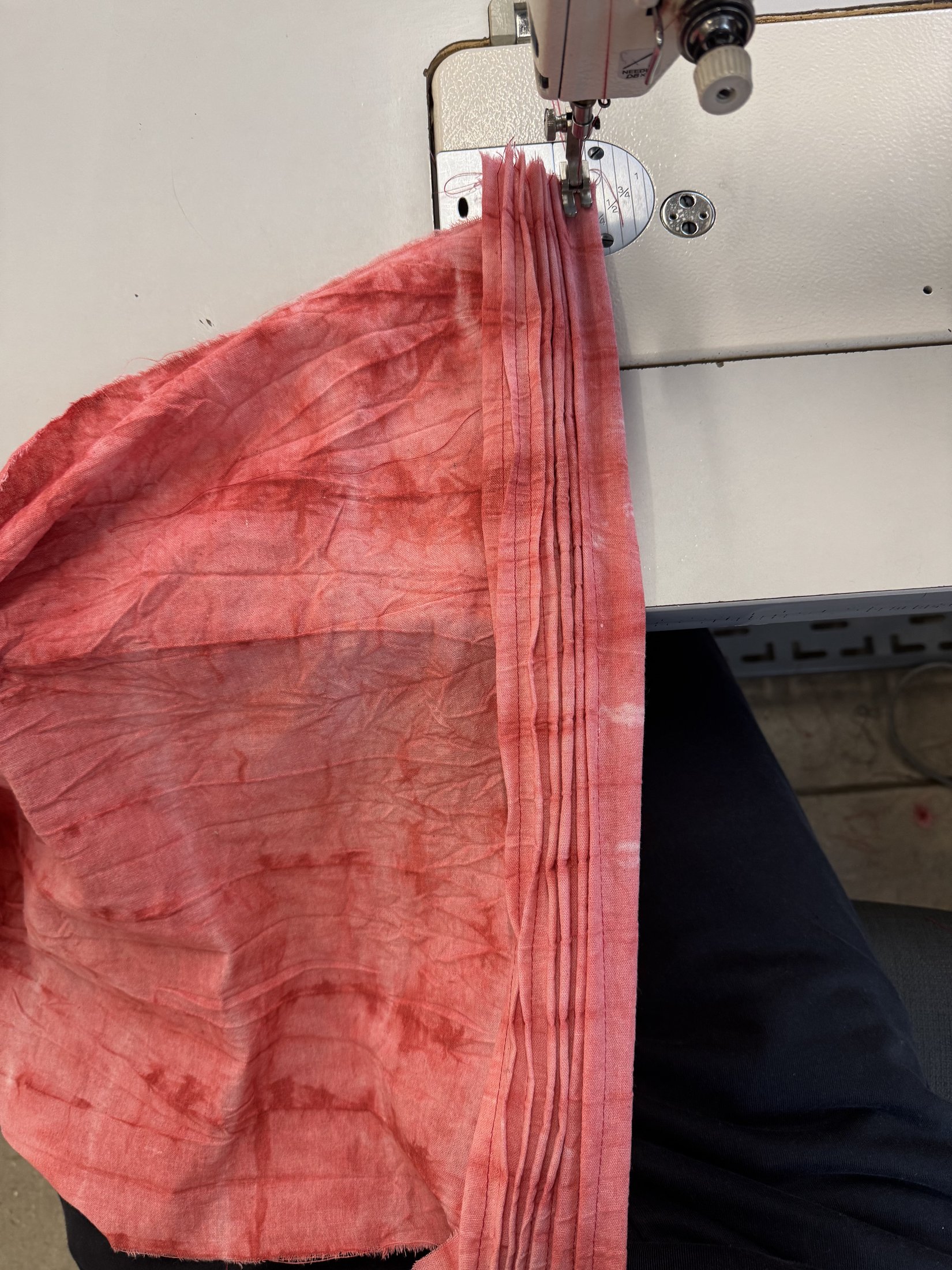 Pink fabric at the sewing machine